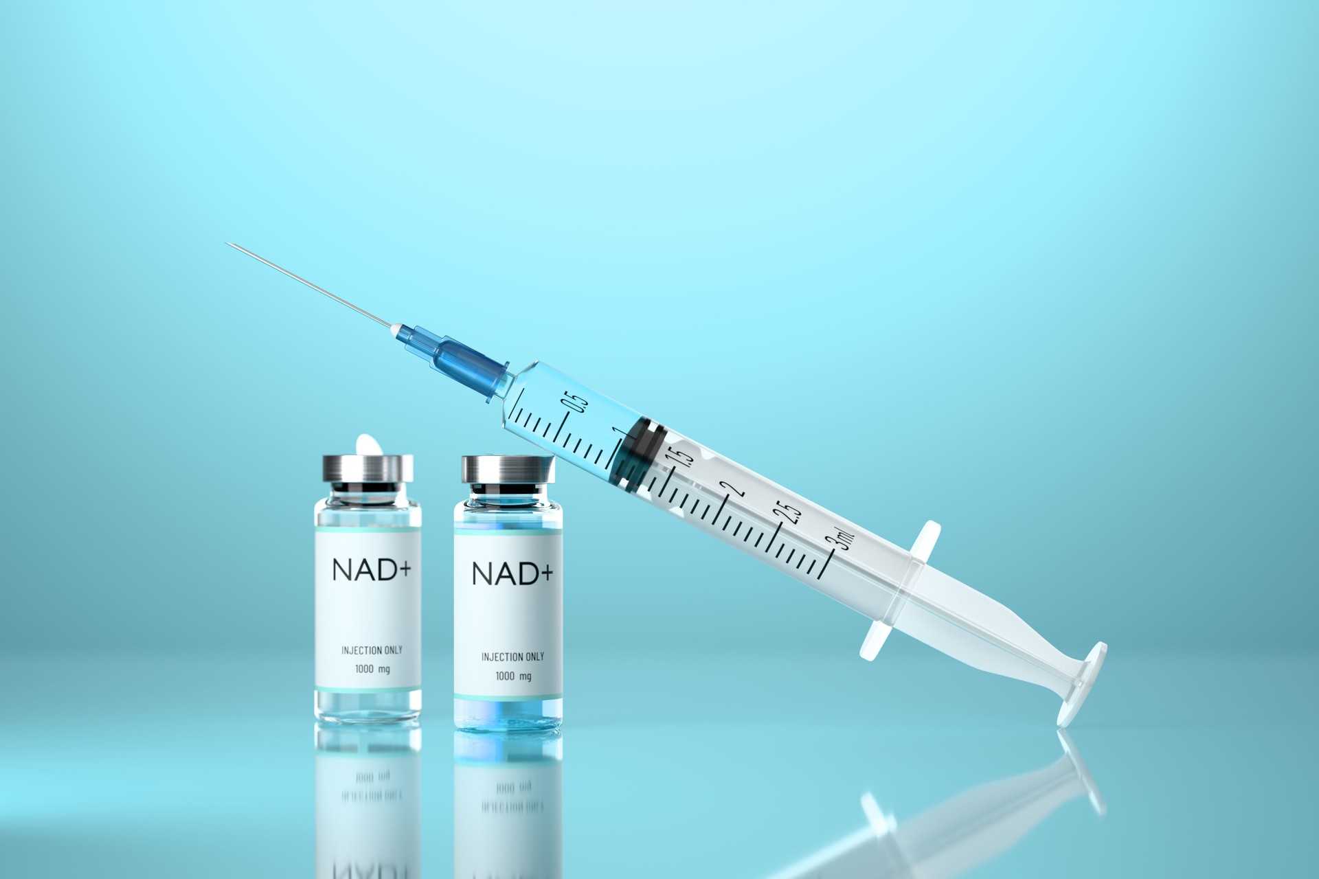 Medical syringe with a needle and a vials with NAD solution on blue background.